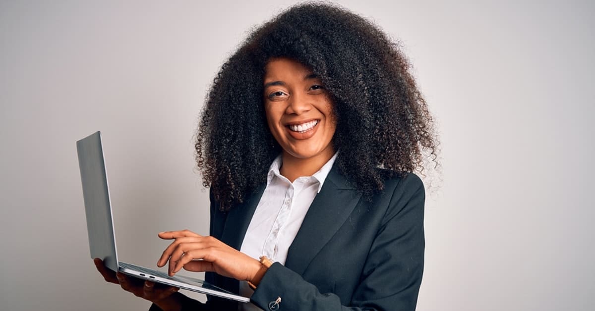 African American Female Professional Smiling Holding Laptop