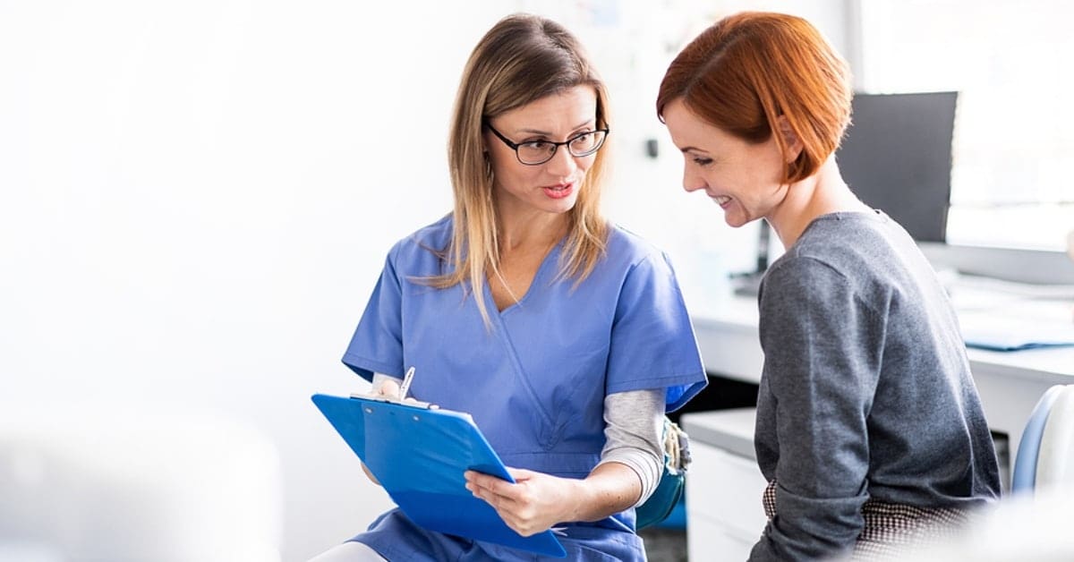 Medical Professional and Woman Discussing Chart