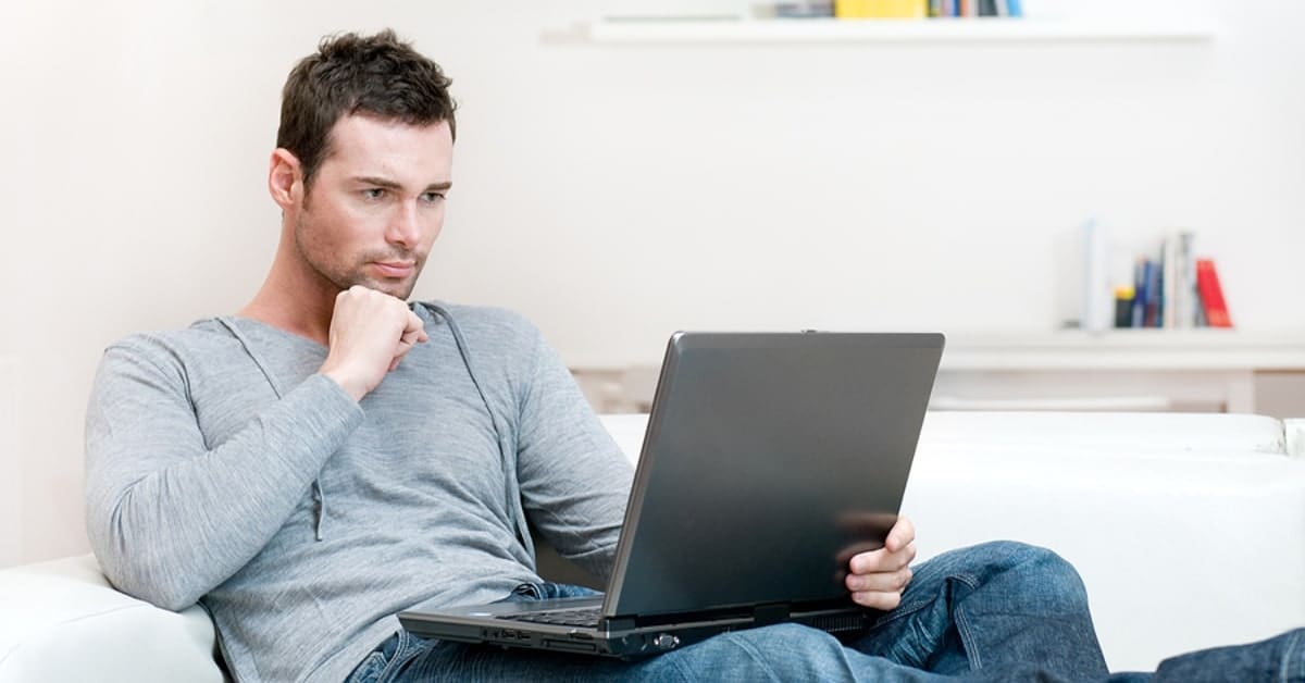 Man Looking Seriously at Laptop