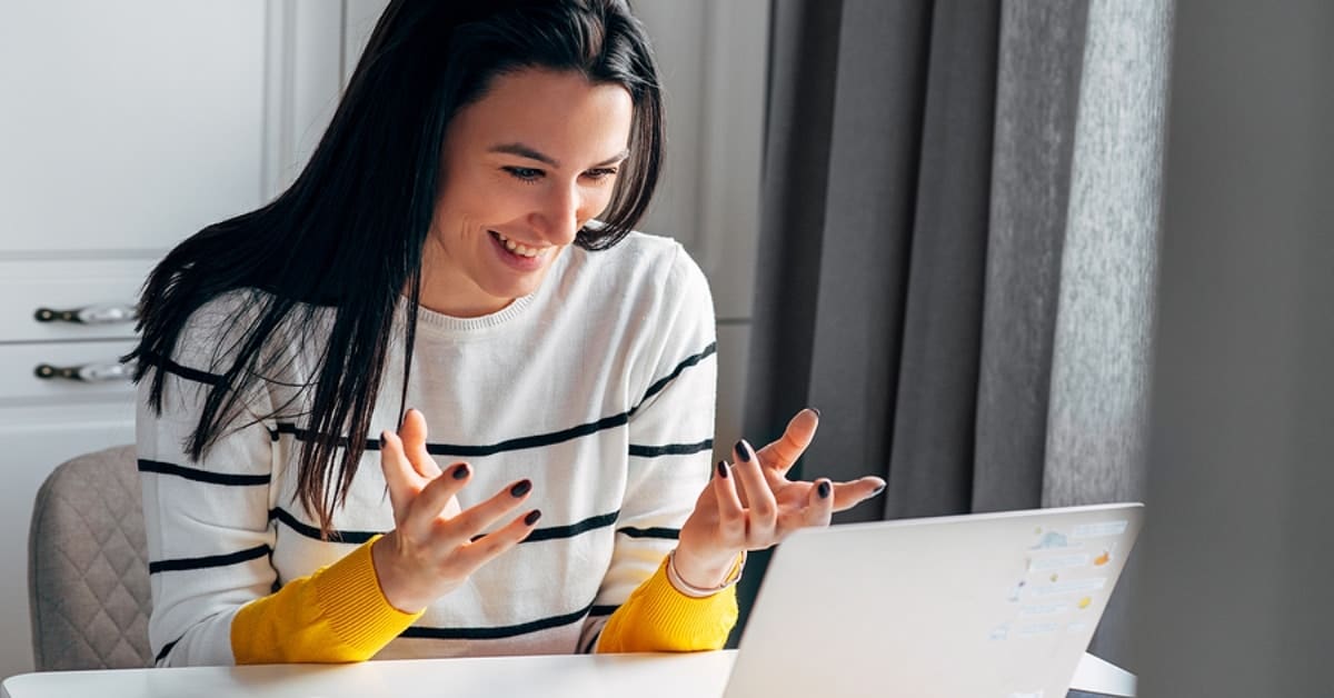 Woman Smiling Looking at Laptop