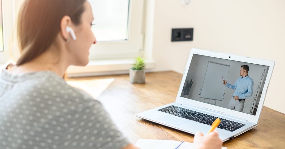 Woman with Earbuds Doing Online School