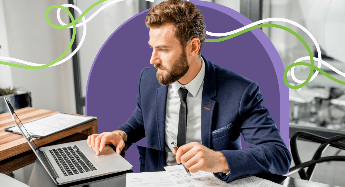 A man in a suit working on his laptop