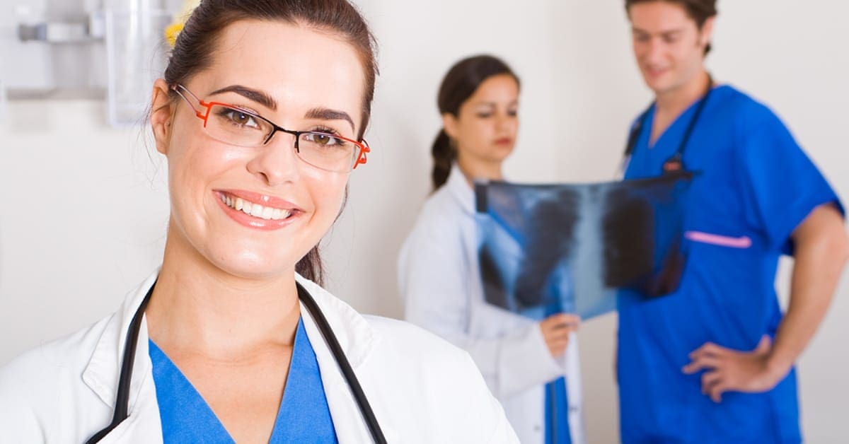 Medical Professional Smiling with Xray in Background