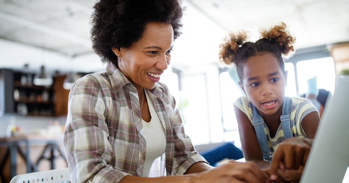 Mother and Daughter Looking at Laptop