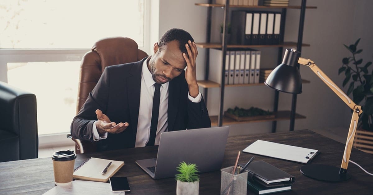 African American Frustrated and Confused Looking at Laptop