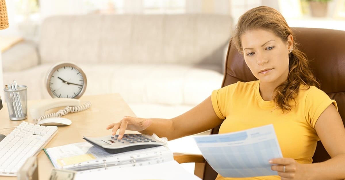 Woman in Yellow Shirt Making Calculations