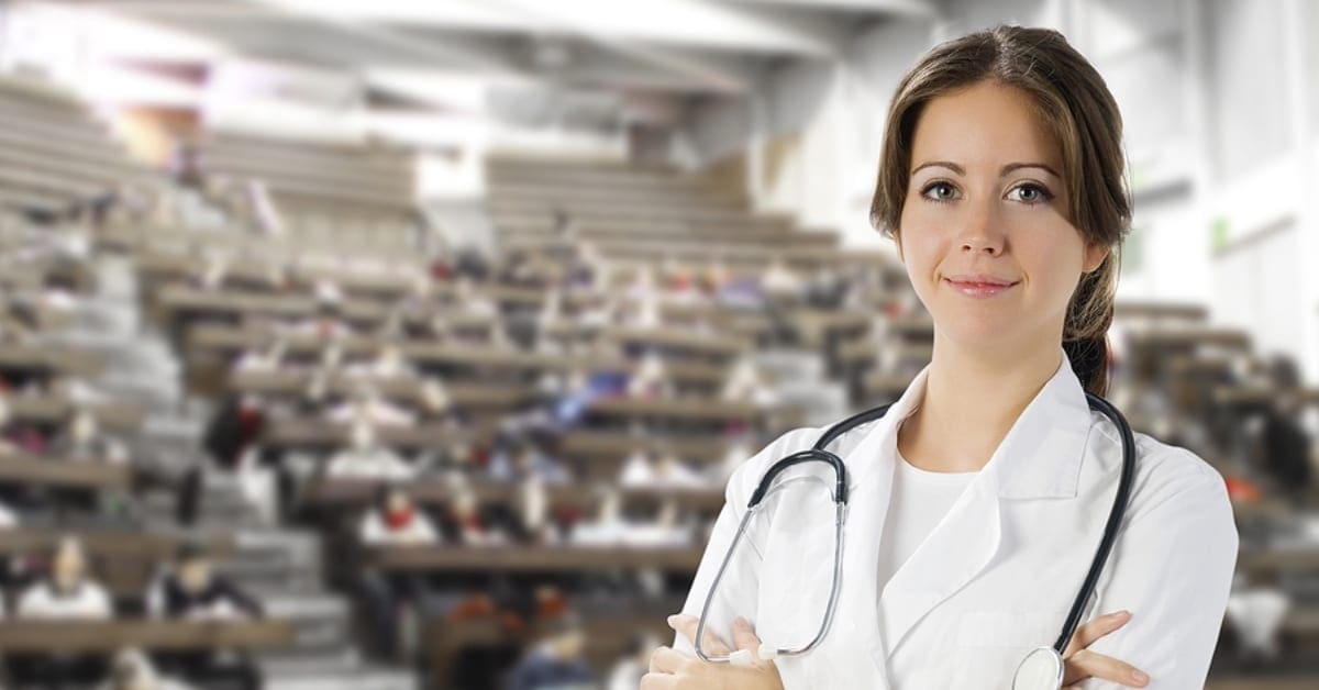 Female Physician Posing in Front of College Auditorium