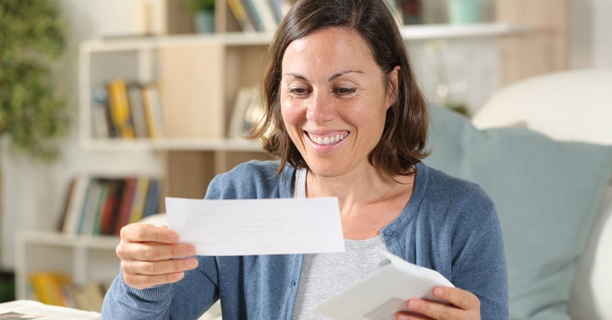 Woman Smiling at Check