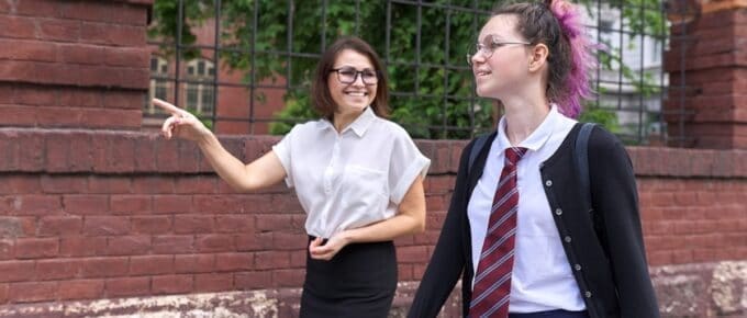Young Female with Pink Hair and Cardigan Walking with a Friend
