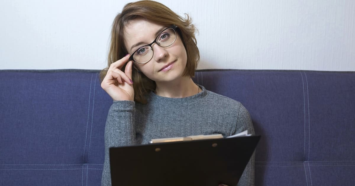 Woman Adjusting Glasses Posing for Camera