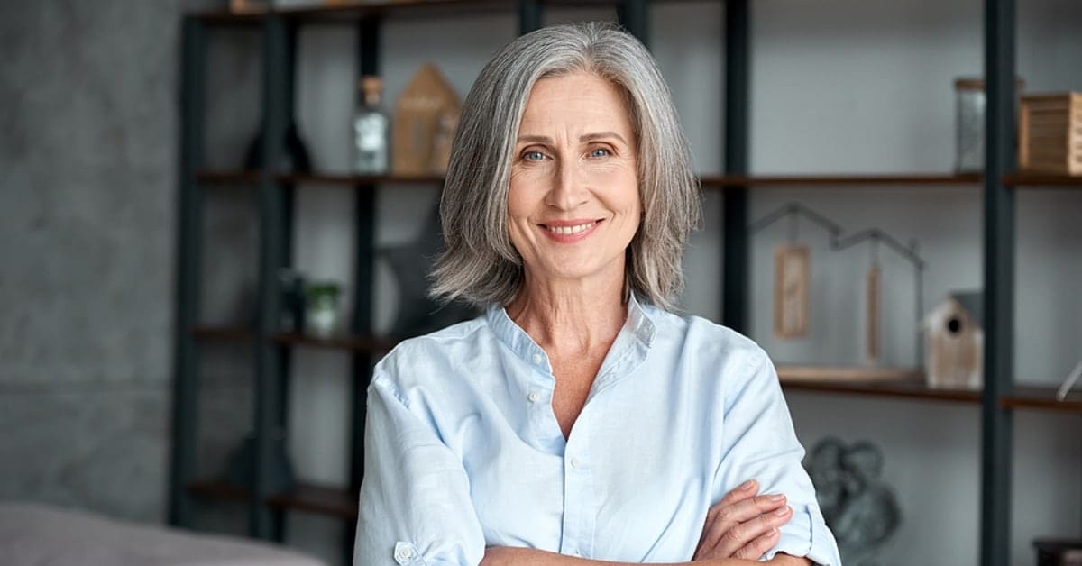 Middle-Aged Woman Arms Crossed Smiling for Camera