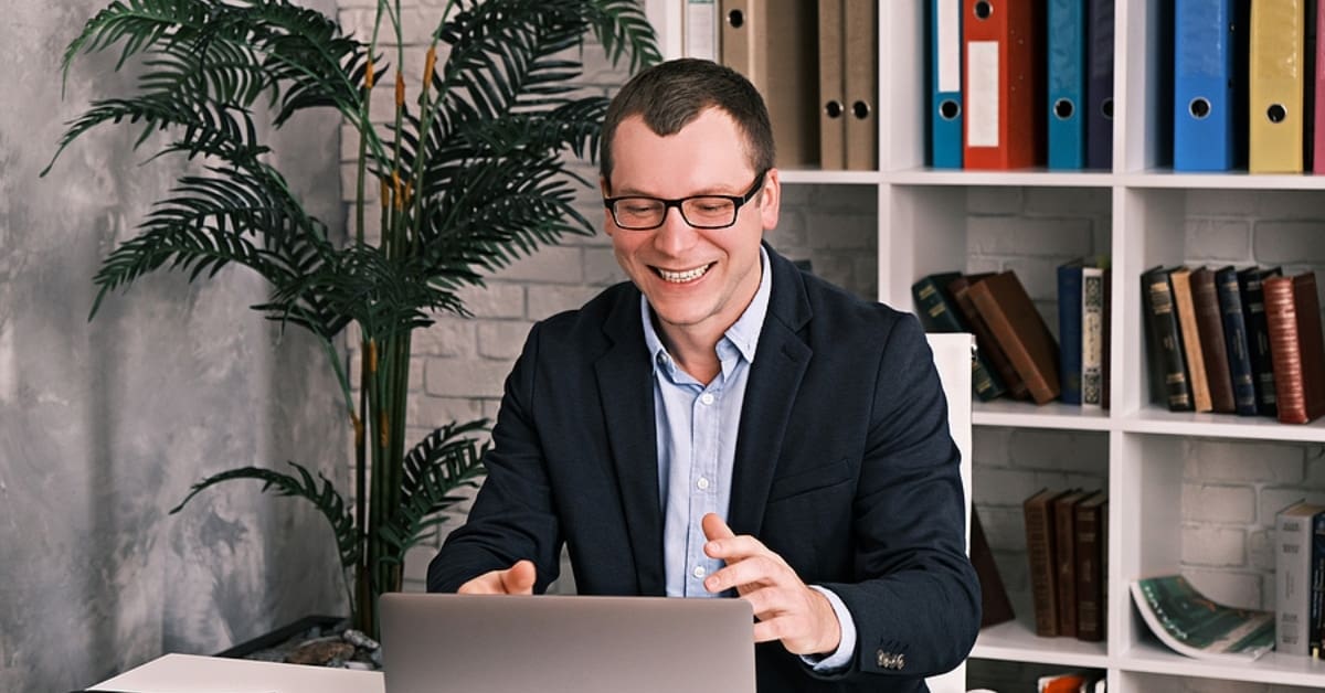 Man Smiling at Laptop