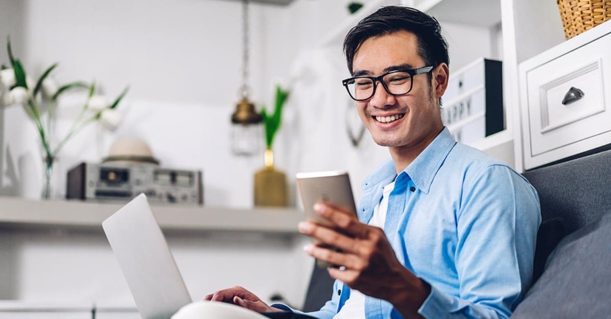 Man Smiling at his Phone