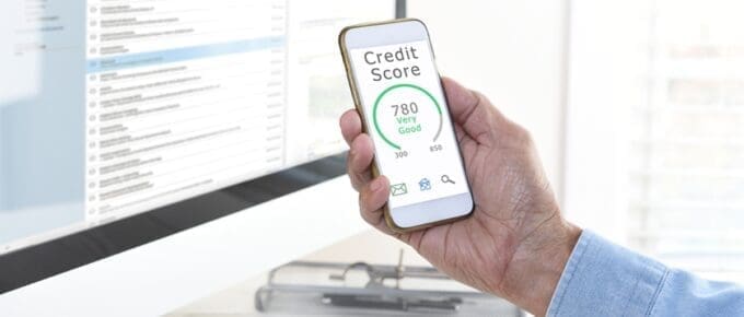 Hand Holding Iphone Showing Credit Score