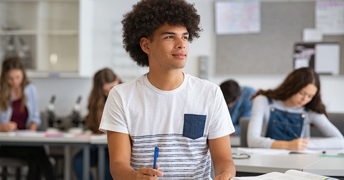 Young Man Smiling in Classroom