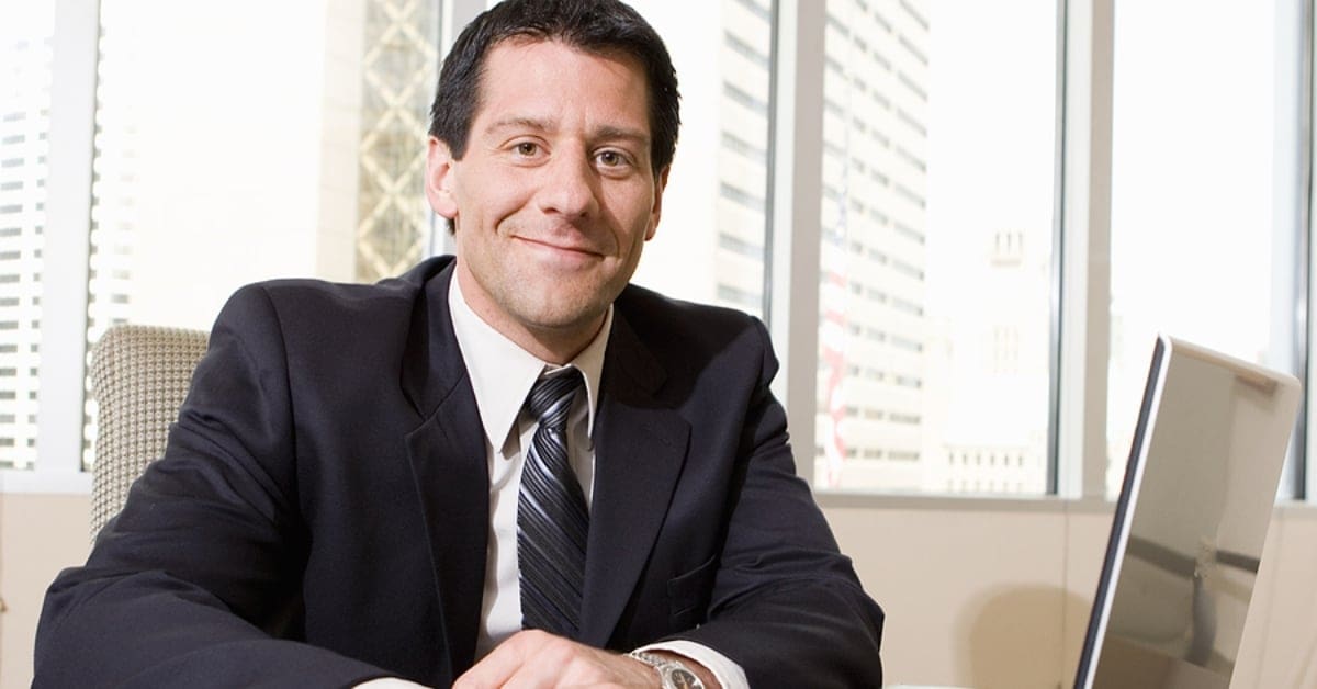 Man in Suit and Tie Lightly Smiling at Camera