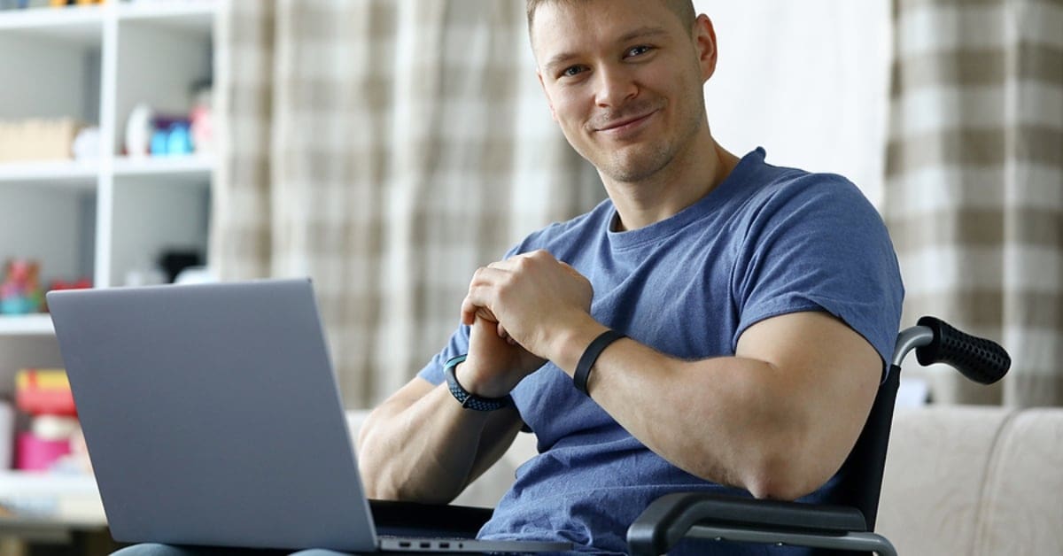 male in wheelchair on laptop