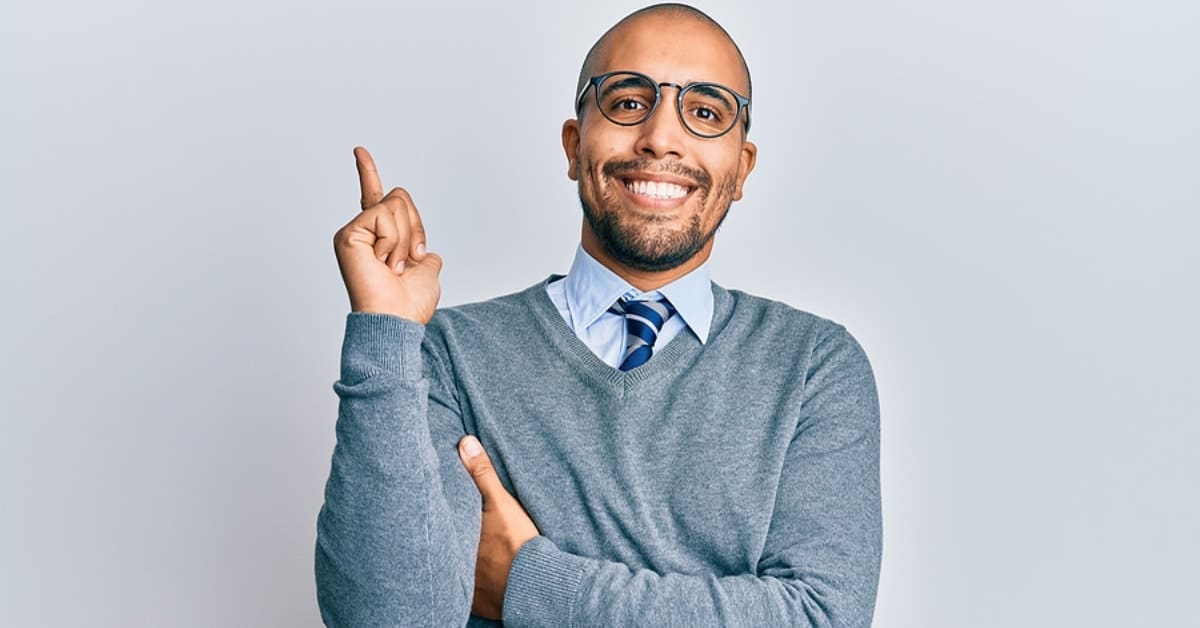 Man Making Pointer Finger Pointing Up and Smiling at Camera