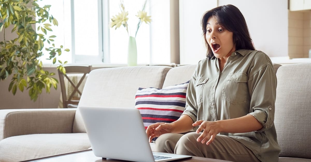 Woman Looking Surprised at Laptop