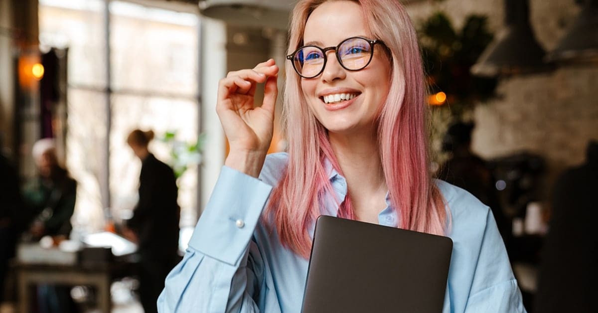 Woman with Pink Hair and Glasses Smiling