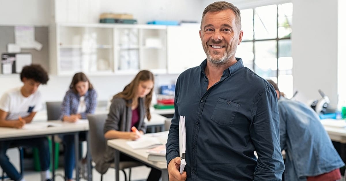 Man Smiling Posing in Classroom