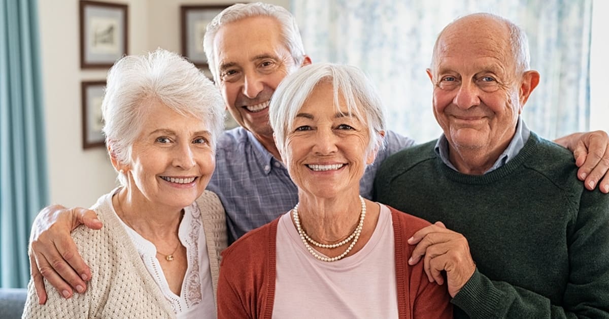 Four Senior Adults Smiling Posing for Picture