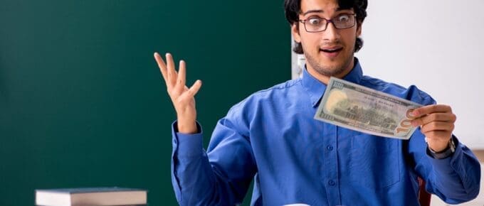 Man Posing with Face of Surprise Looking Down at One Hundred Dollar Bill