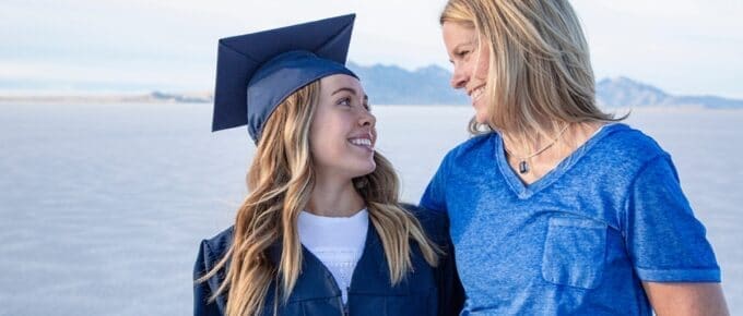 Mother and her Graduated Daughter Smiling at Each other on Graduation Day