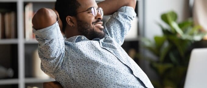 Man Leaned Back Smiling in Chair