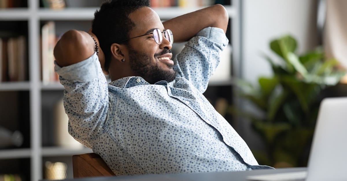 Man Leaned Back Smiling in Chair