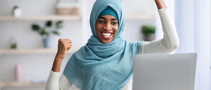 Muslim Woman Celebrating in Front of Laptop