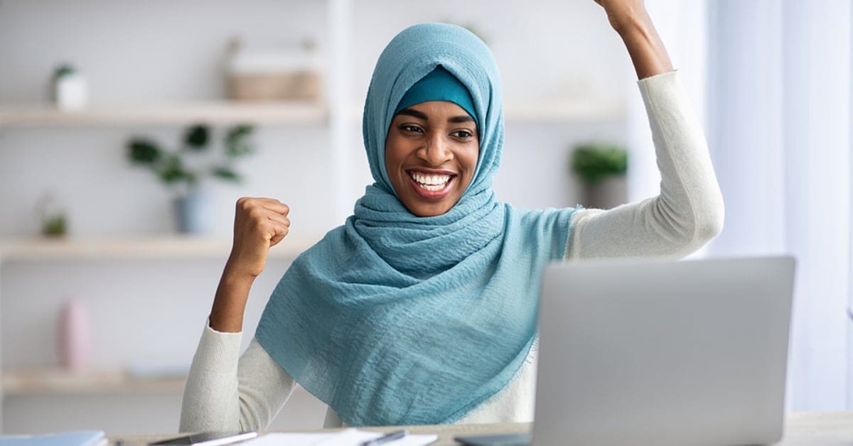 Muslim Woman Celebrating in Front of Laptop