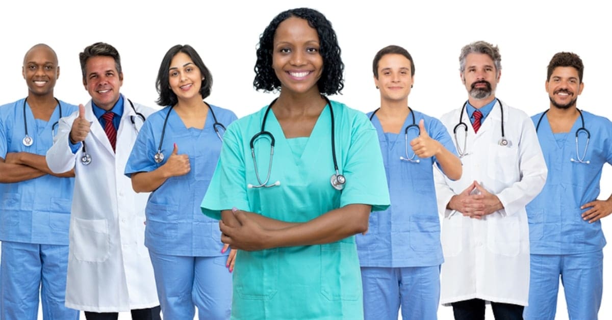 7 Physicians Standing Together Smiling Posing for Camera