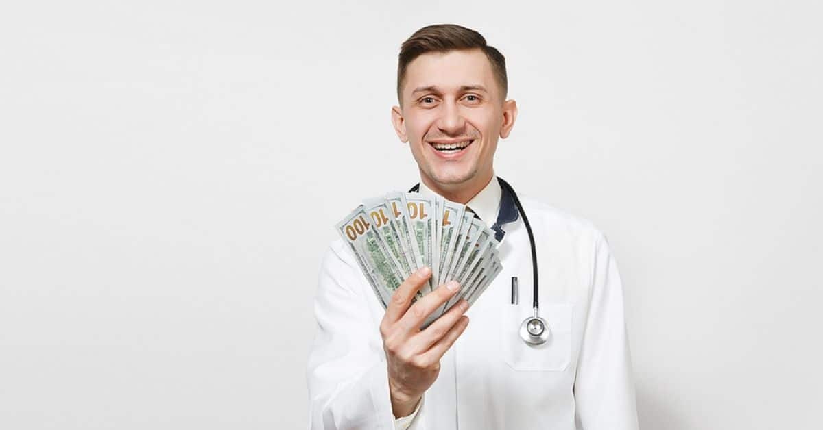 Caucasian Physician Holding Hundreds of Dollars in his Hand Smiling for Camera
