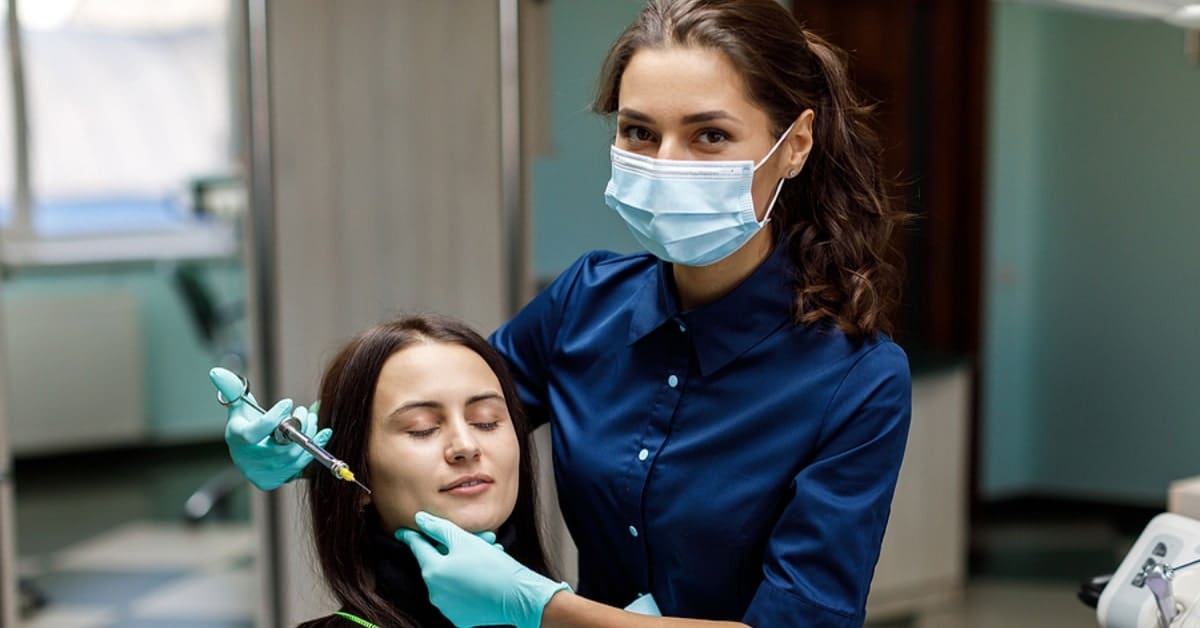 Female Posing with Patient Delivering Injections to Patient's Face