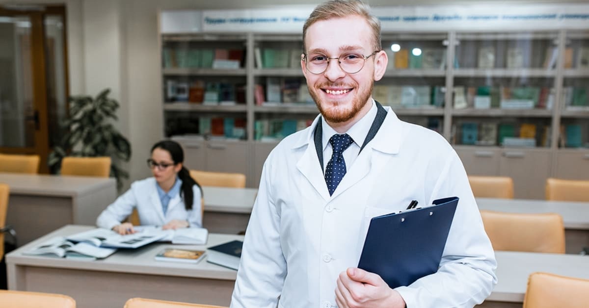 White Man Posing for Camera Smiling in a Library