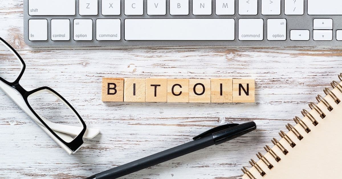 Bitcoin Spelled out on Wooden Blocks in front of Keyboard