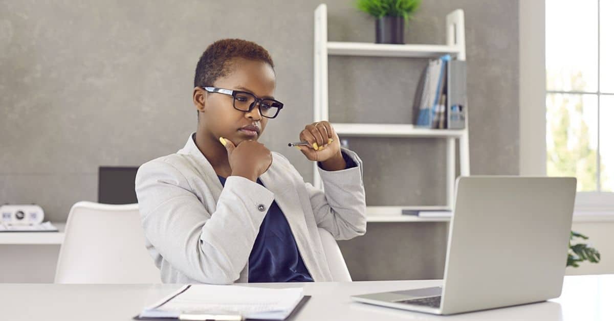 African American Woman Looking Seriously at her Laptop