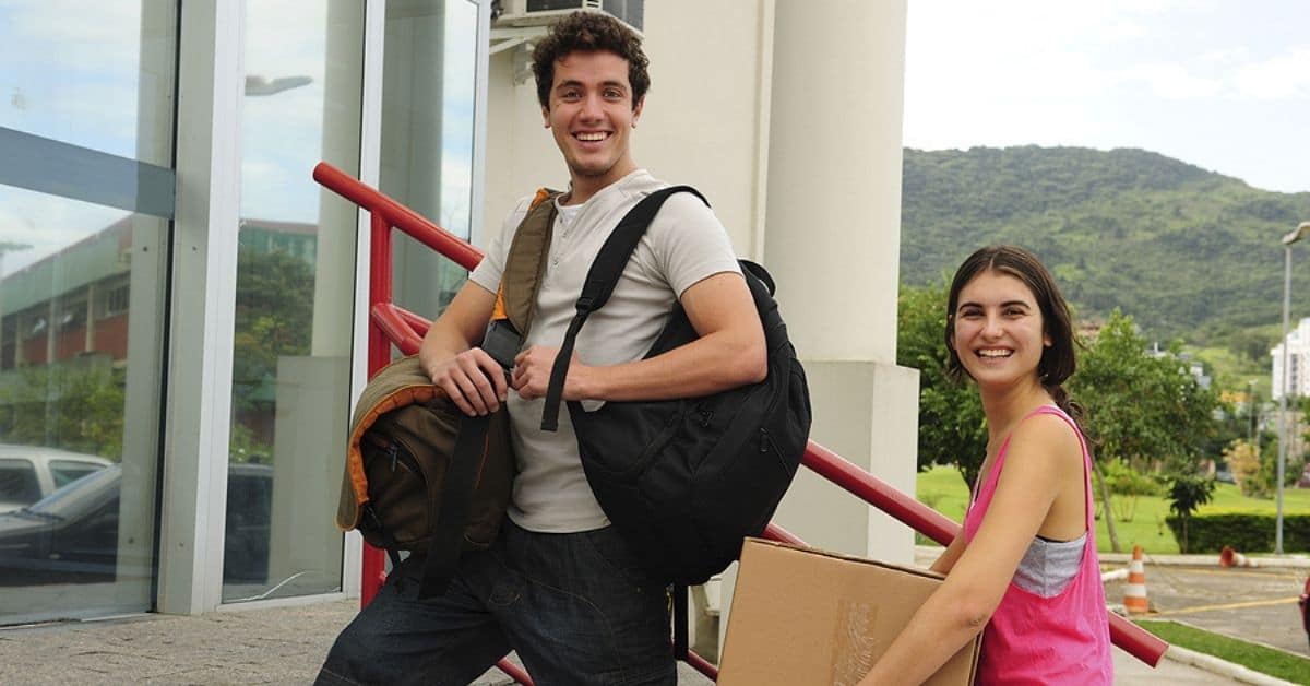 Young Adult Man and Woman Going off to College Posing for Picture