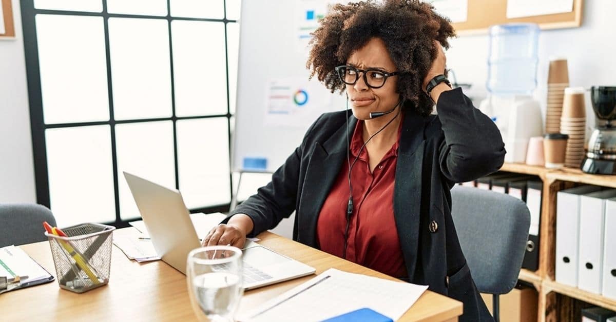 African american woman with afro hair working at the office wearing operator headset confuse and wondering about question.