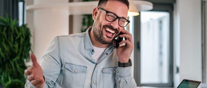 Experienced businessman smiling during a phone call