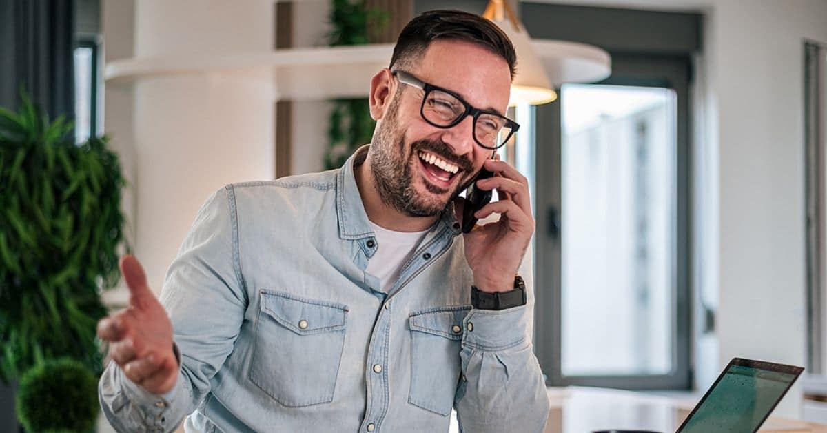 Experienced businessman smiling during a phone call