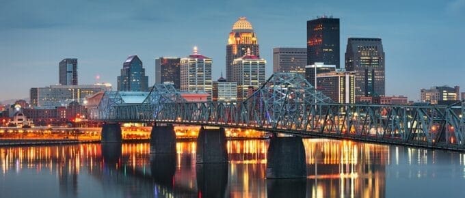 Louisville, Kentucky, USA downtown skyline on the Ohio River at dusk.