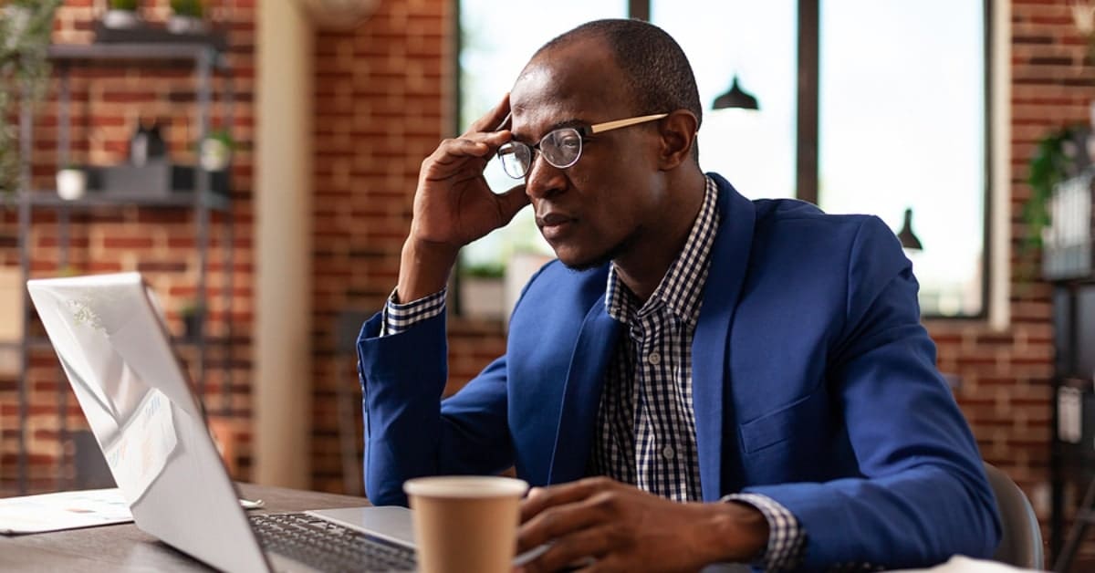 Business man brainstorming solution and working with laptop on marketing strategy. Employee using computer and thinking about financial idea to plan marketing and management.