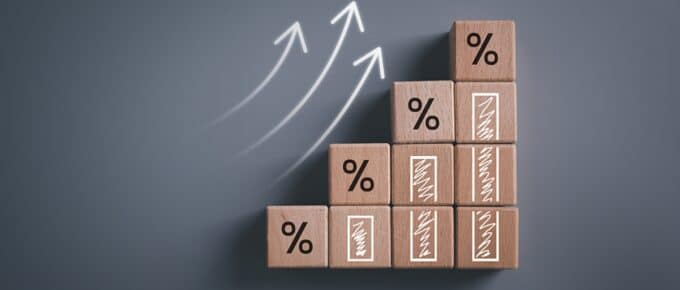 Wooden blocks with percentage sign and arrow up.