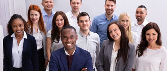 Happy Group Of Business People Standing In Office