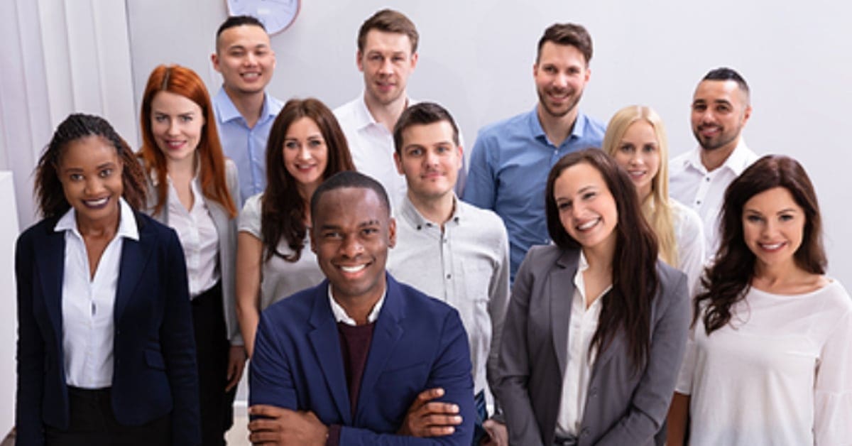 Happy Group Of Business People Standing In Office