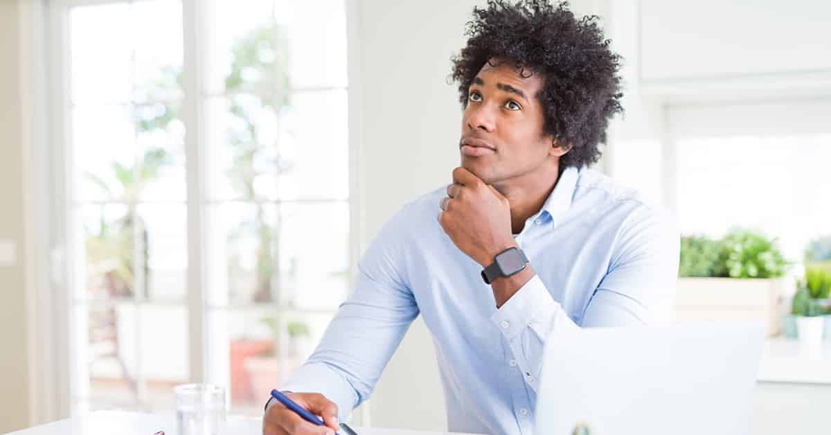 African American business man working writing on notebook serious face thinking about question, very confused idea