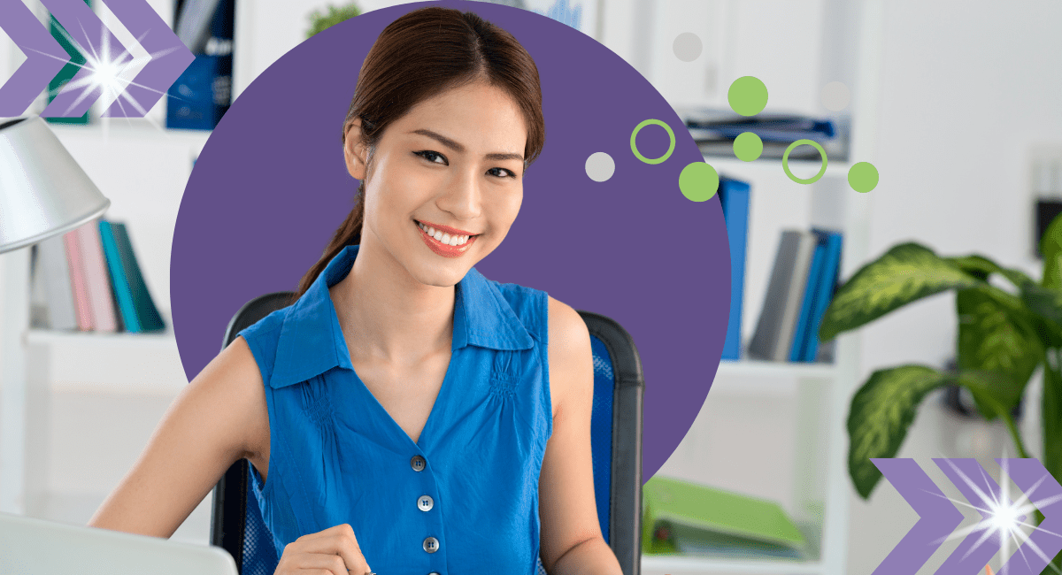 A woman smiling at a desk