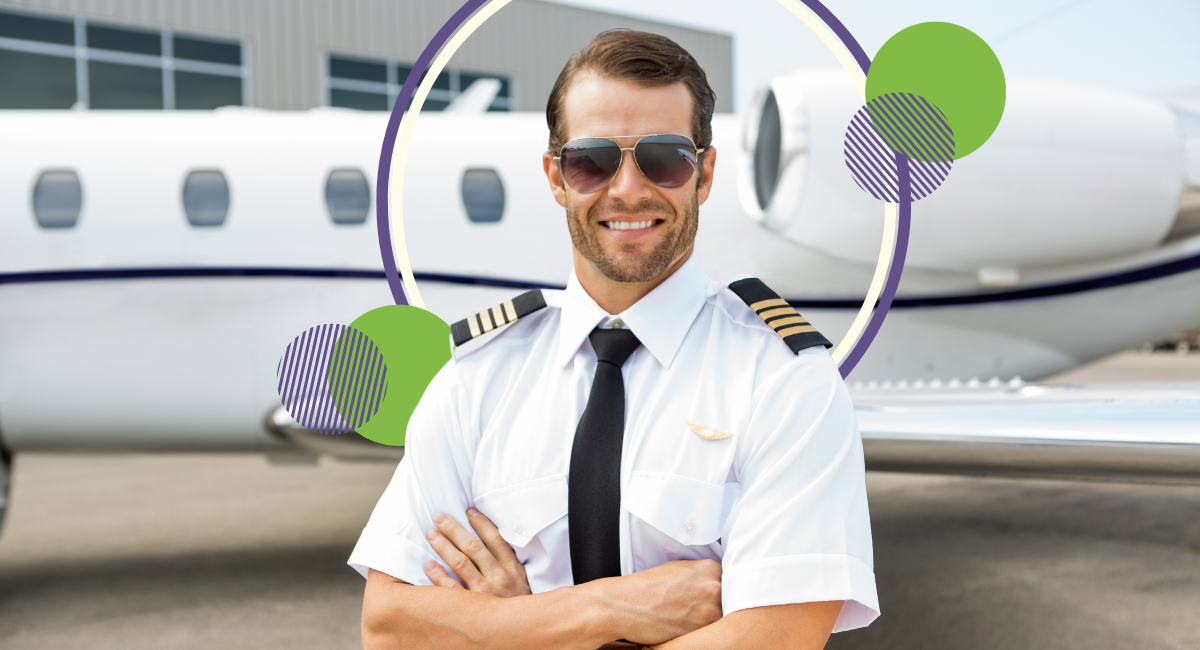 male pilot with arms crossed in front of a plane, wearing sunglasses